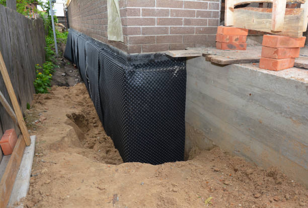 SJ Waterproofing Pros technician performing targeted Wet Basement Repair assessment in Huntsville, TN